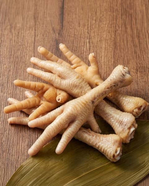 Free-range chicken bones on parchment, exceptionally collagen-rich and simmered 36 hours for skin, joints and gut