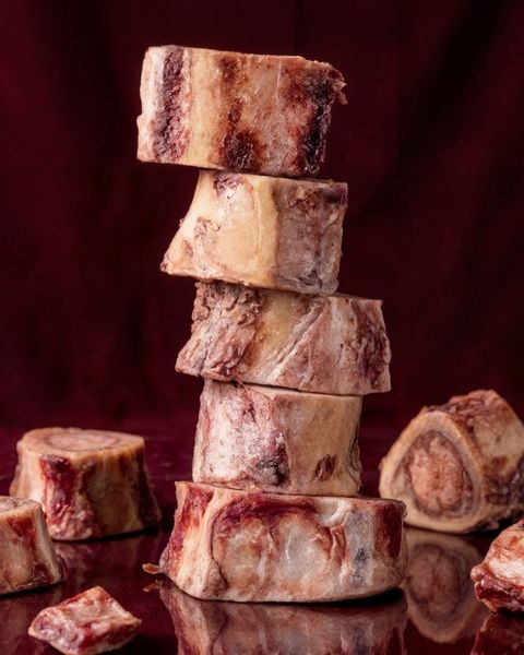 Grass-fed beef bones on parchment, slow-cooked 36 hours for collagen, glycine and immune-supporting minerals